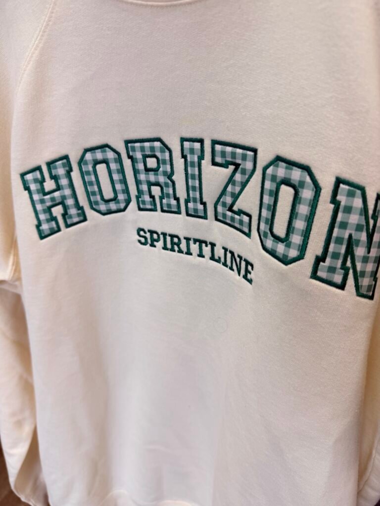 Applique embroidered lettering on a crewneck sweatshirt, made in Phoenix Arizona