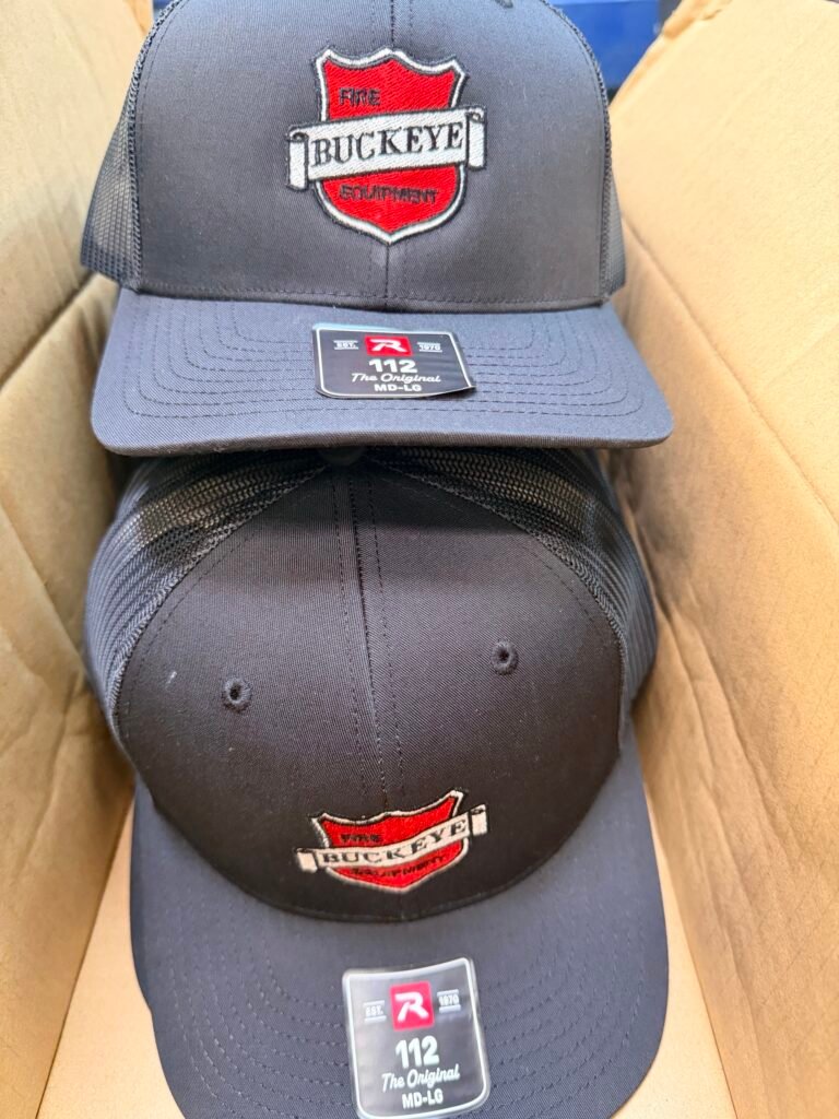 Two Richardson 112 caps embroidered with the same company logo in different colorways